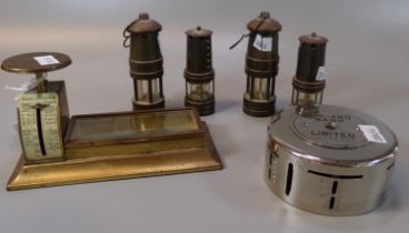 Four miniature miners lamps, together with a midland Bank money box and table top postal scales with