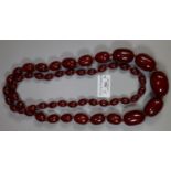 Heavy dark red long string of graduated beads. (B.P. 21% + VAT)