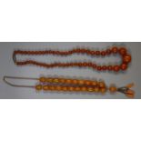 Two strings of amber type beads. (B.P. 21% + VAT)
