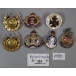 Small collection of military pin badges and fobs etc. To include; The Suffolk Regiment and