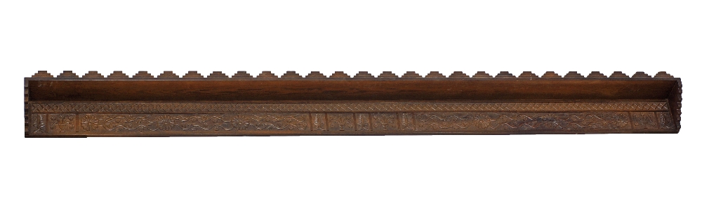 A Cypriot carved stained pine wood wall shelf
