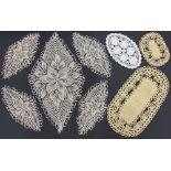 A collection of oval shaped crocheted and embroidered table mats