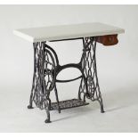 A Singer iron base with a white marble top