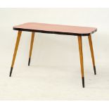 A beechwood and Formica laminate undulating oblong table