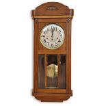 An Arts & Crafts cased oak train striking wall clock