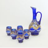 A blue glass Bohemian pitcher and glasses