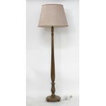 A floor lamp on turned wood stand