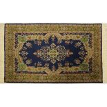 A Persian / Syrian carpet hand woven in dark blue ground