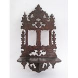 A Cypriot carved pinewood folding wall hanging shelf