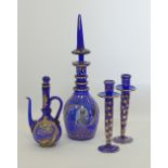 A collection of Bohemian blue glass decanters and candleholders