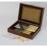 A set of silver plated and carved bone or ivory dessert knives and forks