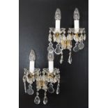 A pair of two light - two arm crystal sconces