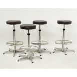 A set of four chrome plated tubular steel and black leatherette adjustable stools