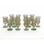A set of twelve Syrian or Hebron light green mouth blown footed glasses