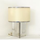 A modern three sided mirror like, metal table lamp