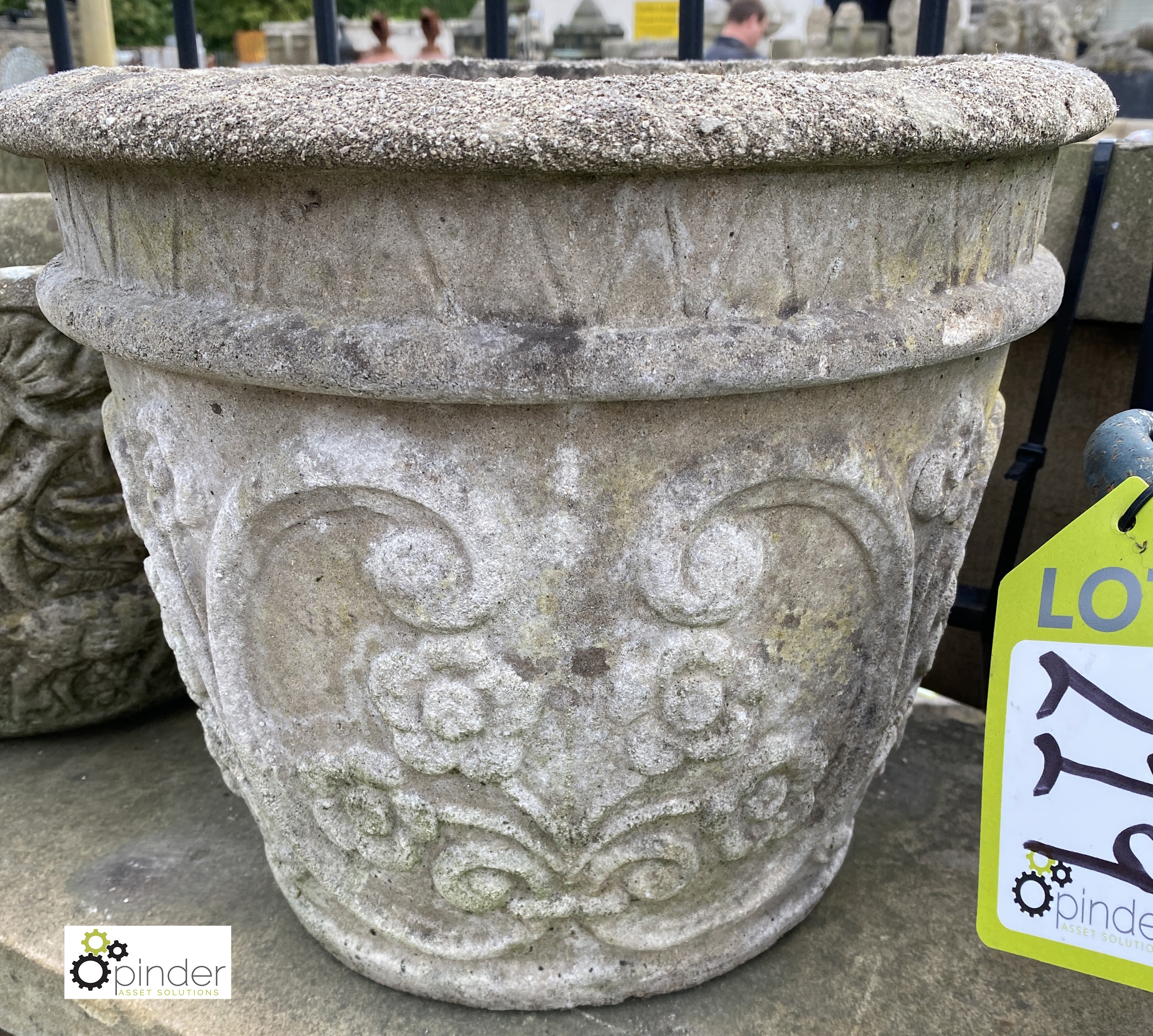 A reconstituted stone Planter, with flower decoration, 12in high x 14in diameter