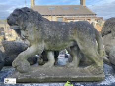 A reconstituted stone Lion Statue, with its foot on the ball representing supremacy over the
