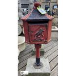 A cast iron Letterbox, on a Yorkshire Stone base, with horse and jockey decoration, 40in high