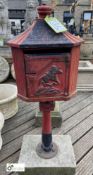 A cast iron Letterbox, on a Yorkshire Stone base, with horse and jockey decoration, 40in high