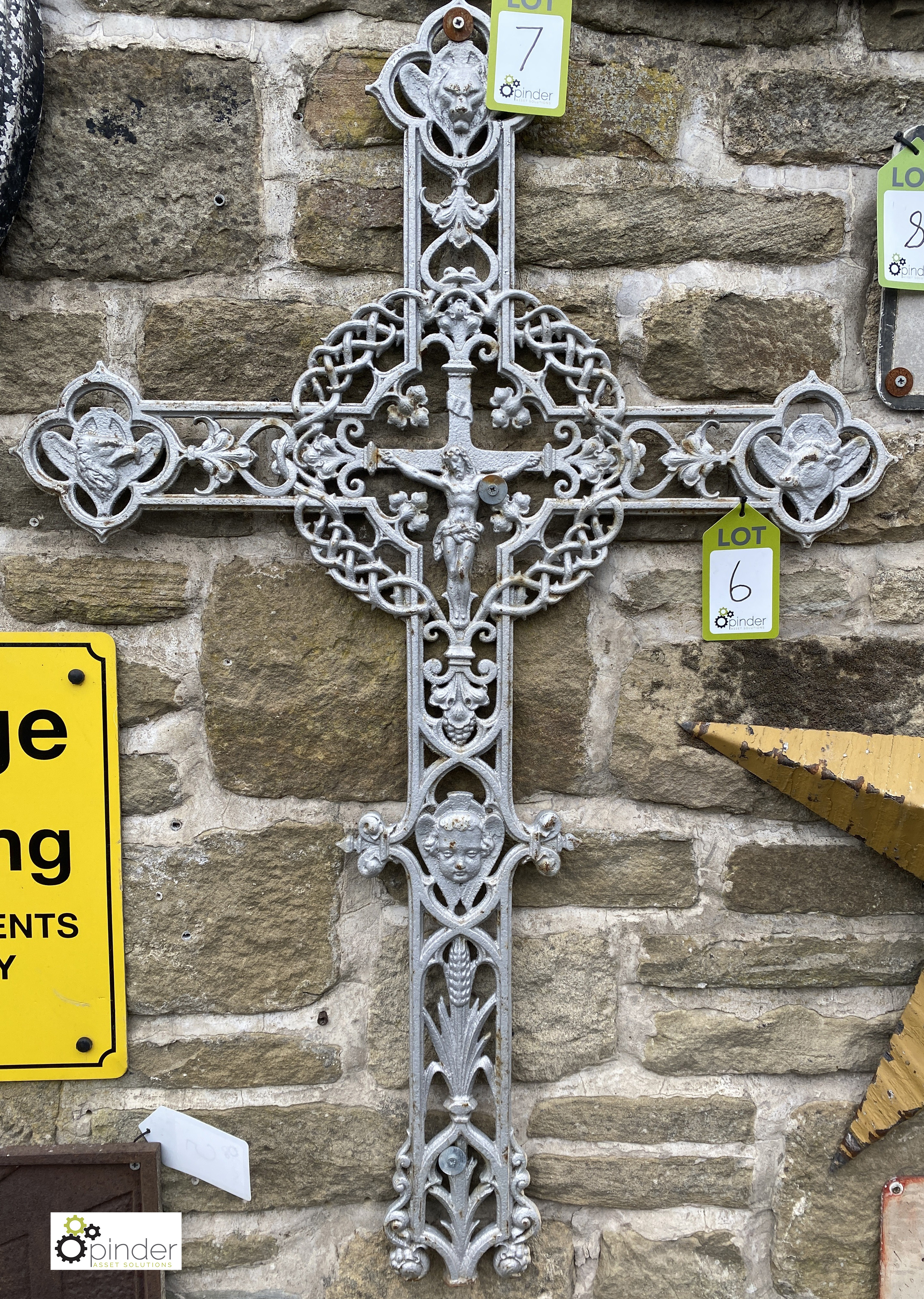 An antique decorative cast iron Crucifix, with an eagles head, lion and ox surrounded by Jesus, in a