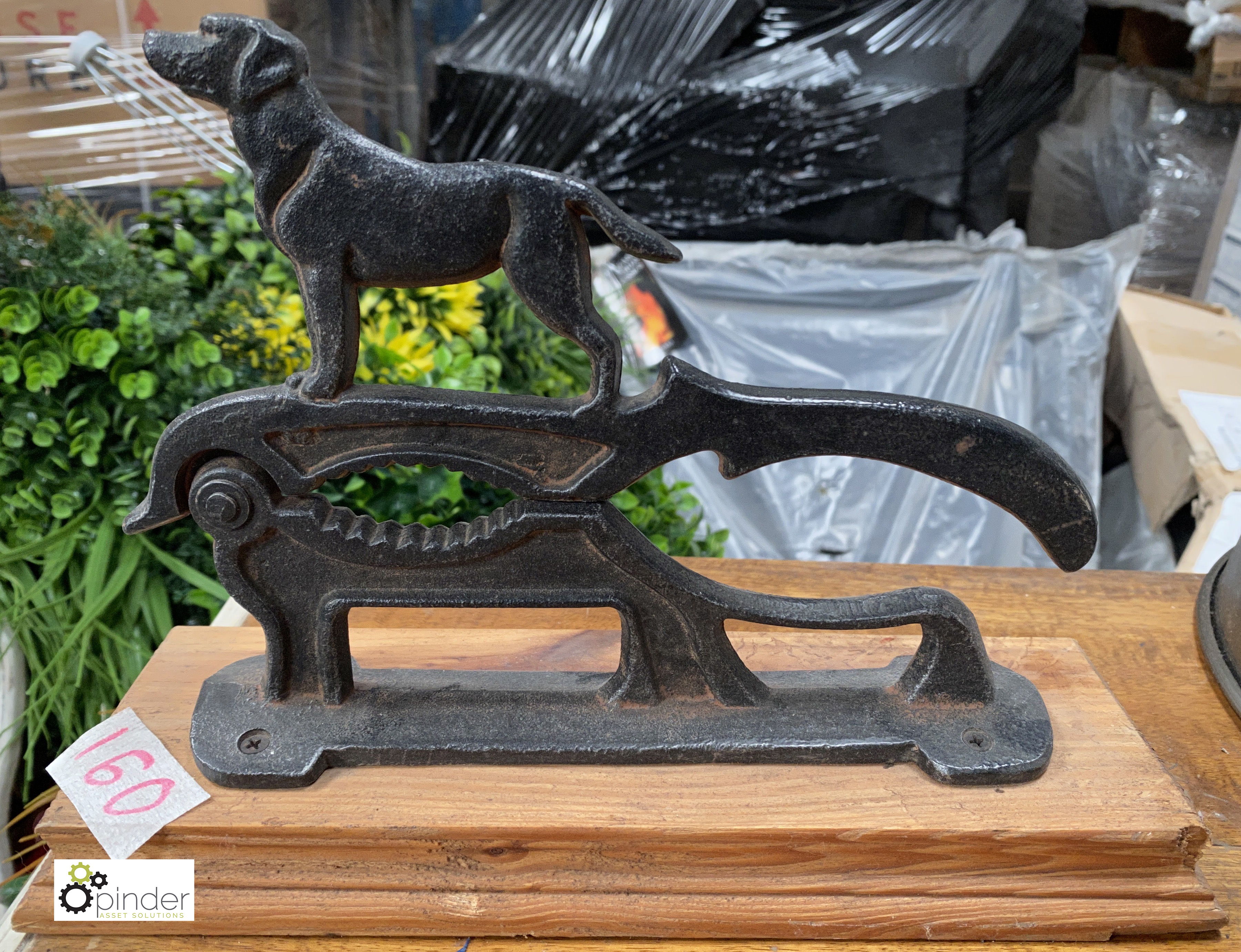 A cast iron Dog Nut Cracker mounted on wood base