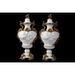 A PAIR OF VERY LARGE 19TH CENTURY FRENCH GILT BRONZE MOUNTED SÈVRES STYLE BISCUIT PORCELAIN VASE AND