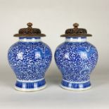 A pair of 19th Century blue and white Chinese porcelain jars with wood covers