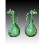 A PAIR OF NEAR-IDENTICAL GREEN-GLAZED ÇANAKKALE EWERS OTTOMAN TURKEY, 19TH CENTURY