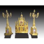 A patinated and gilt bronze cathedral clock garniture with porcelain Plaques By Andre Hoffman