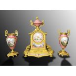 AN ORMOLU-MOUNTED SÈVRES STYLE 'JEWELLED' PINK-GROUND CLOCK GARNITURE