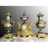 A FRENCH ORMOLU-MOUNTED SEVRES-STYLE COBALT BLUE JEWELLED PORCELAIN THREE-PIECE CLOCK GARNITURE