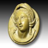 A GREEK SOAPSTONE PENDANT OF A NOBLE WOMAN,