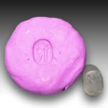 A NEO BABYLONIAN CHALCEDONY STAMP SEAL DEPICTING A GOD PRAYING TOWARDS THE SUN