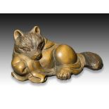 A WOOD NETSUKE OF A TANUKI, MEIJI PERIOD