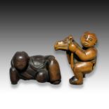 A WOOD NETSUKE OF CHILD ON A ROCKING HORSE & A RECLINING MAN, MEIJI PERIOD