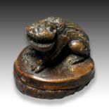 A BAMBOO NETSUKE DEPICTING A SHI SHI DOG, MEIJI PERIOD