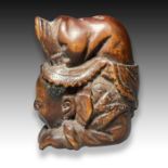 A WOOD NETSUKE OF A CHILD IN AN ACROBATIC FORM, MEIJI PERIOD