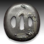 AN IRON TSUBA DEPICTING SCENES OF NAUTRE