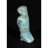 AN EGYPTIAN FAIENCE AMULET OF A PRISONER, PTOLEMAIC PERIOD CIRCA 664- 30 B.C.