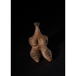 A MESOPOTAMIAN TERRACOTTA FEMALE IDOL, TEL HALAF TYPE CIRCA 5000-4500 B.C.