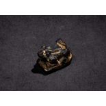 AN EGYPTIAN BLACK GRANITE AMULET OF A FROG, THIRD INTERMEDIATE PERIOD OR LATER