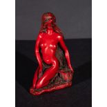 A RED DYED FIGURED OF A NUDE WOMAN