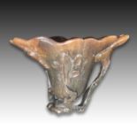 A RARE CHINESE RHINOCEROS HORN 'LOTUS LEAF' LIBATION CUP, QIANLONG PERIOD (1736-1795)