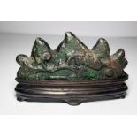 A CHINESE BRONZE BRUSH REST IN THE SHAPE OF A MOUNTAIN, QING DYNASTY OR EARLIER