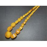 A LARGE UNUSUAL CUT AMBER NECKLACE