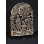 A GHANDARA SCHIST PLAQUE WITH A STANDING FIGURE OF A BUDDHA BEING GREATED BY ATTENDANTS, 3RD CENTURY
