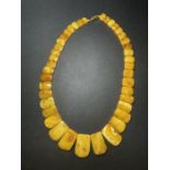 A GRADUATED AMBER NECKLACE