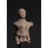 AN INDUS VALLEY HARAPPA TERRACOTTA SEATED FEMALE FIGURE, 2ND MILLENIUM B.C