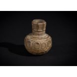 A LATE SASANIAN CUT GLASS BOTTLE CIRCA 6TH CENTURY A.D