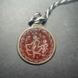 A STAMP SEAL OF A CUPID ON AGATE, SET AS A PENDANT 20TH CENTURY